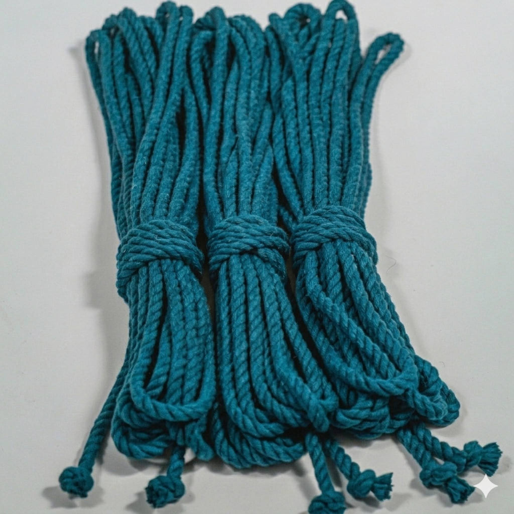 Teal cotton ropes tied together on a light gray background